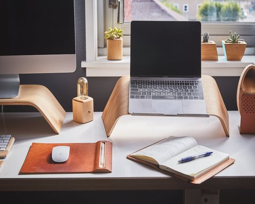 Organized desk with laptop and notebook